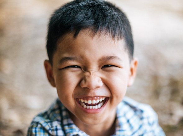 closeup of child smiling outside 