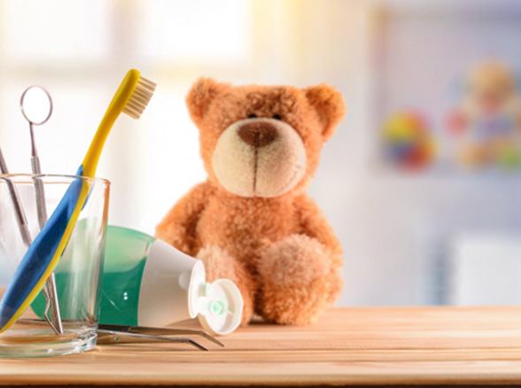 Teddy bear on counter with dental tools