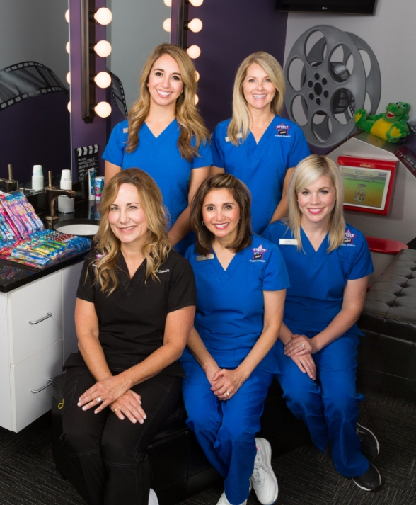 Coppell pediatric dentist and dental team members in dental office