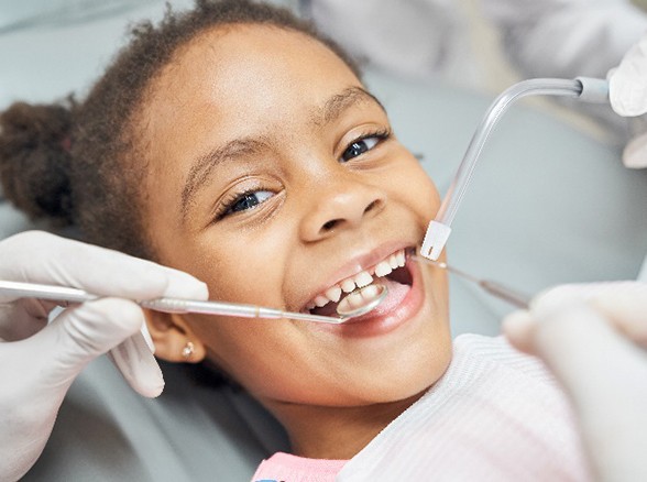 Young girl smiling during routine dental cleaning