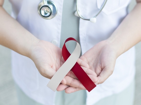 Dentist holding an oral cancer screening awareness ribbon