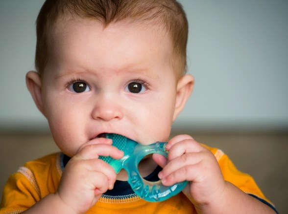 Baby chewing on teething ring