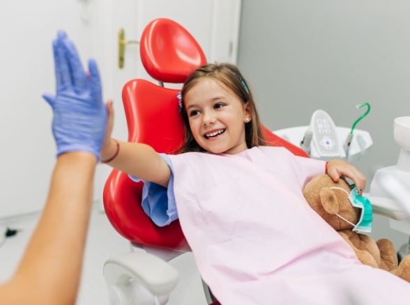 Child giving dentist a high five