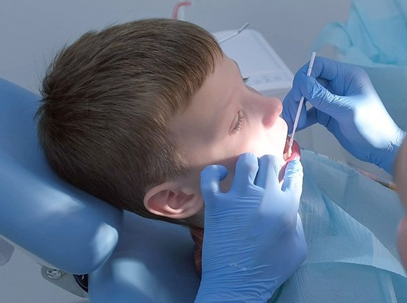 Child receiving fluoride treatment