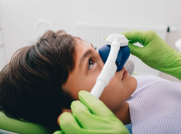 Child receiving nitrous oxide sedation dentistry treatment