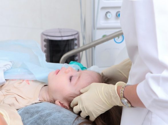 Child receiving dental treatment under general anesthesia