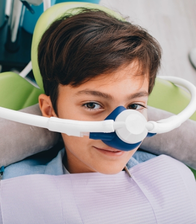 Child wearing nitrous oxide sedation dentistry mask