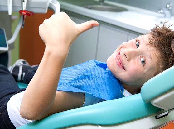 child smiling while visiting the dentist