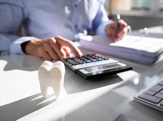 dental professional calculating costs with insurance