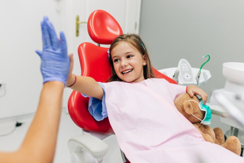 child talking to a dentist in a dentist’s chair