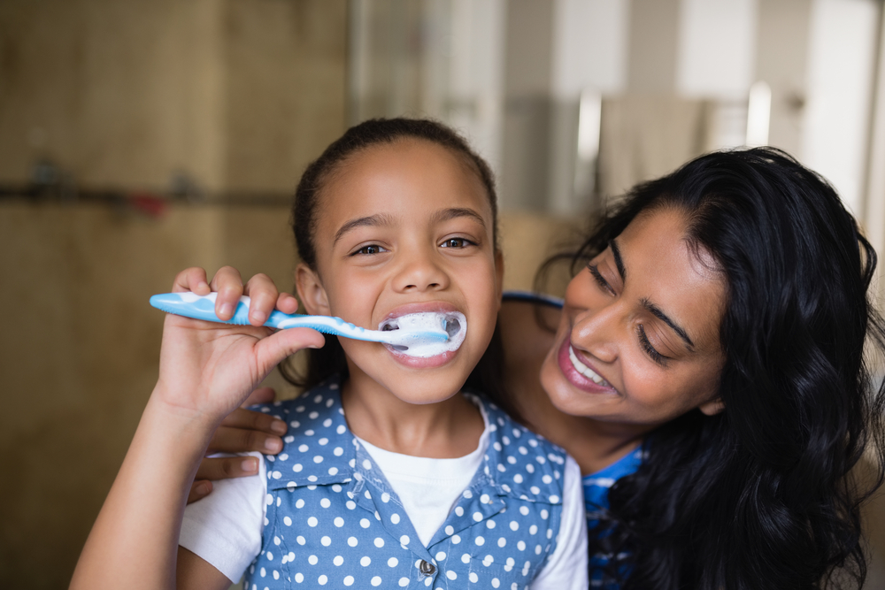 child using an electric toothbrush