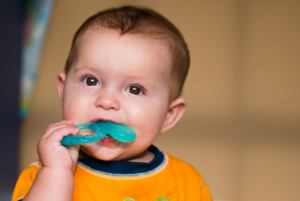 an image of a child biting a teething ring