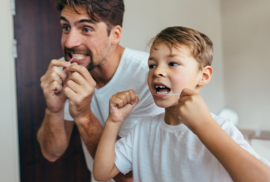 Father and son flossing