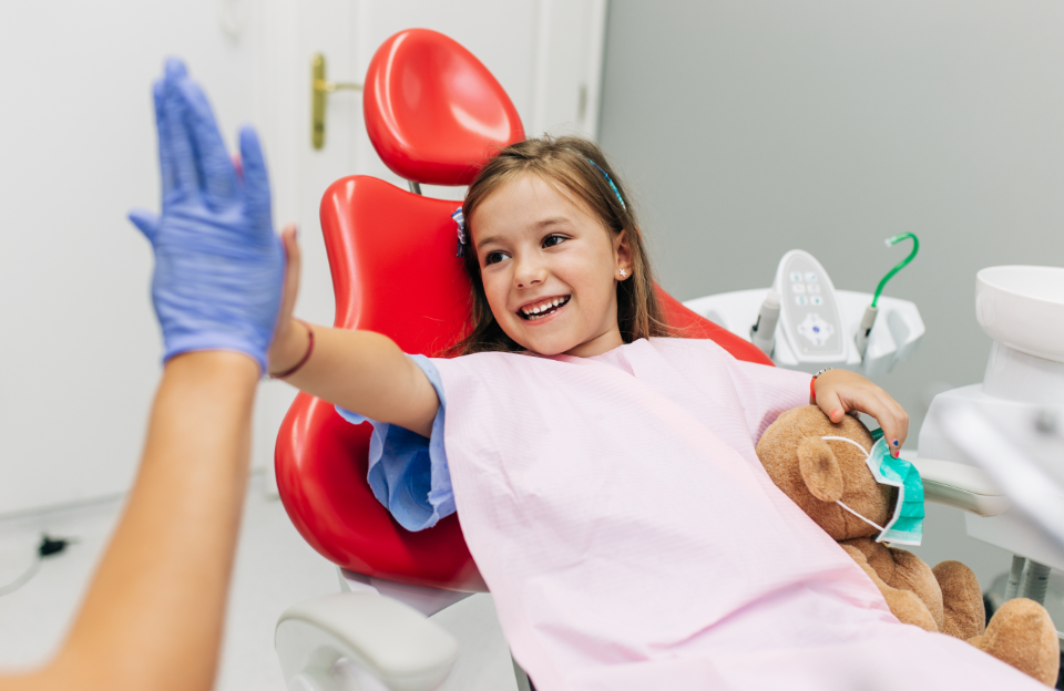 Child high fiving dentist